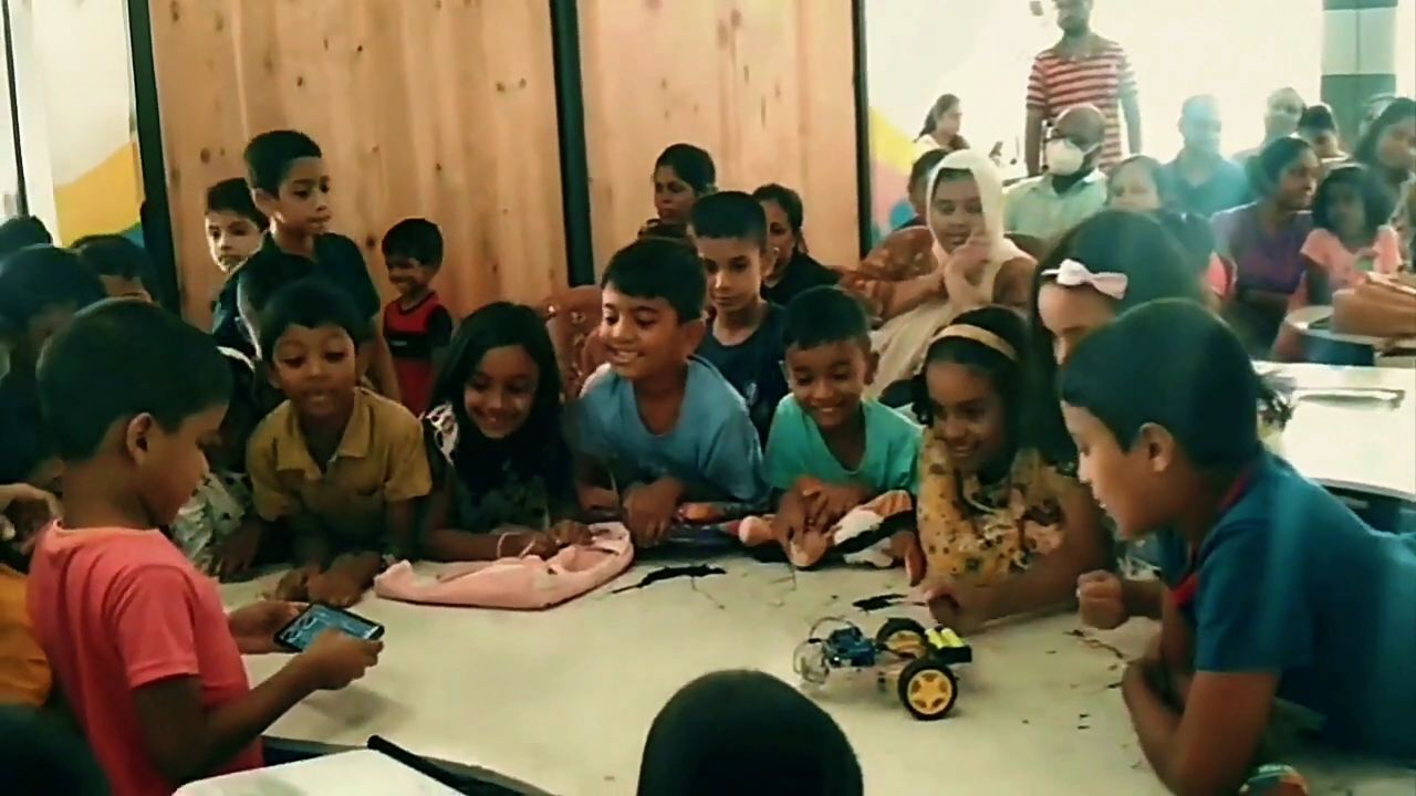 Learners gathered around their completed robot car
