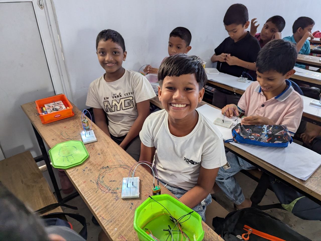 Smiling students with their electronics kits in Panadura